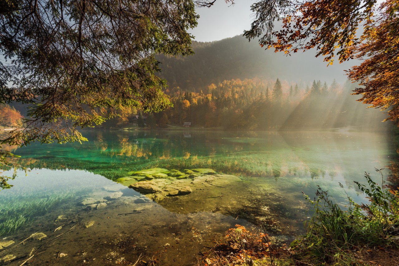 Clear water in Fusine lake with sunsine .